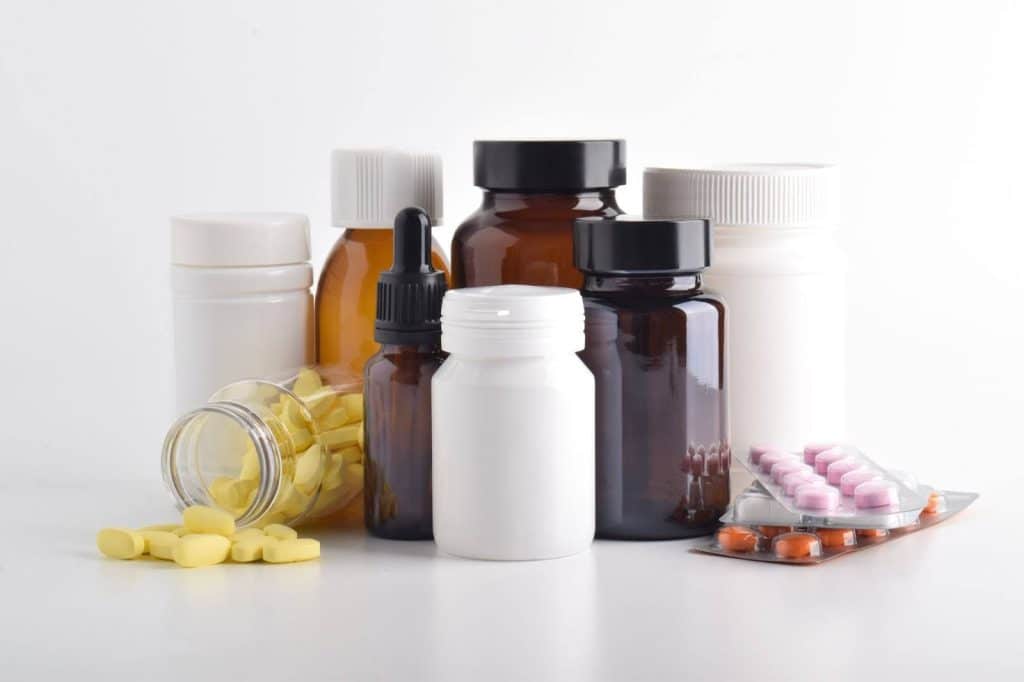 Various pills and medicine bottles on a white background