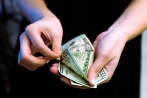 person holding fan of 100 us dollar