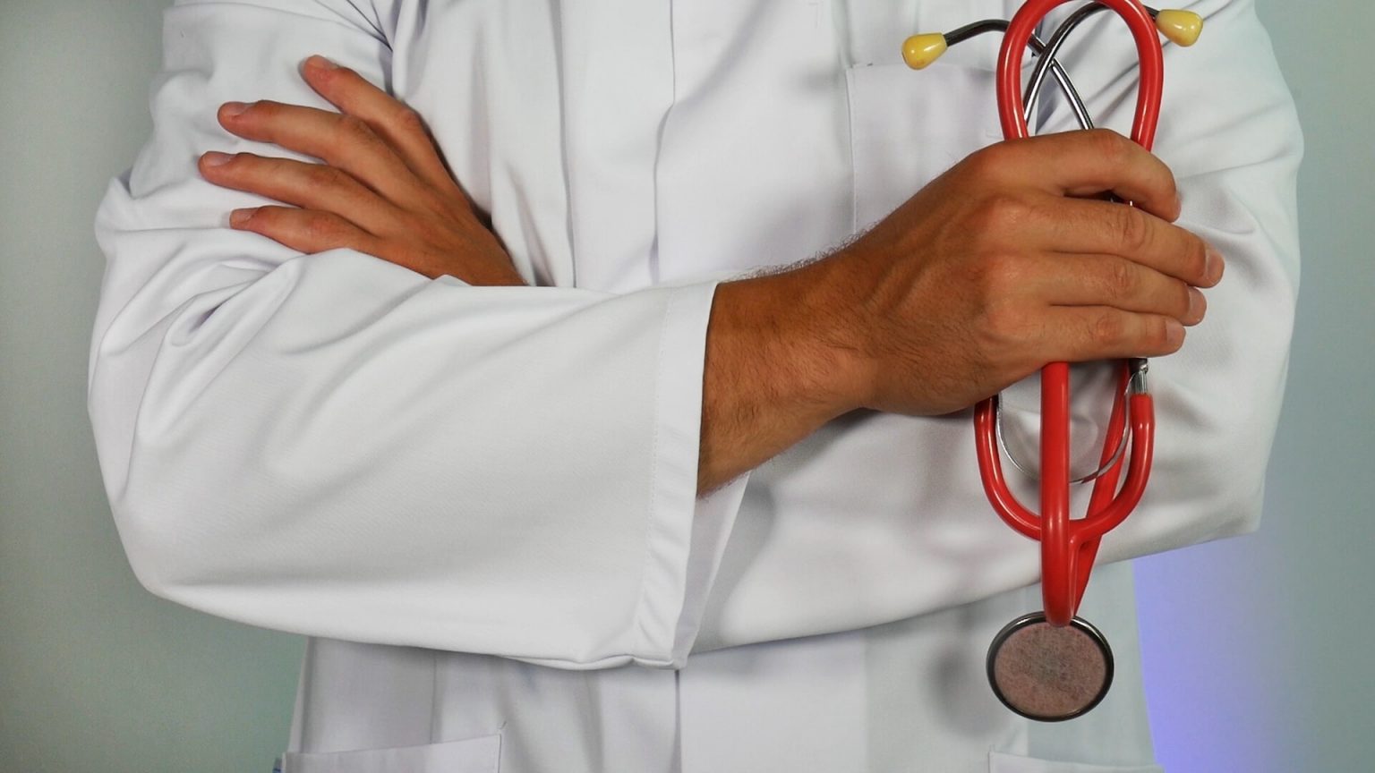 doctor holding red stethoscope photo