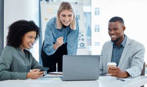 business team reading good news on a laptop